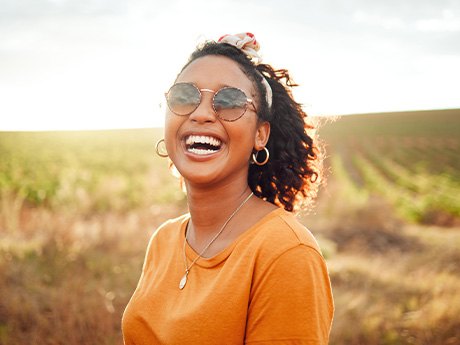 Woman smiling with new dental crowns