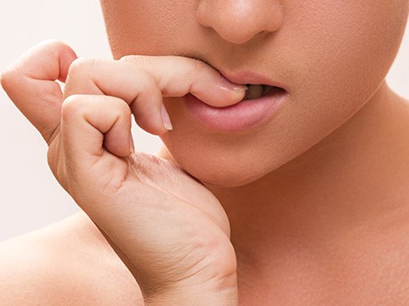 Closeup of patient biting their nails