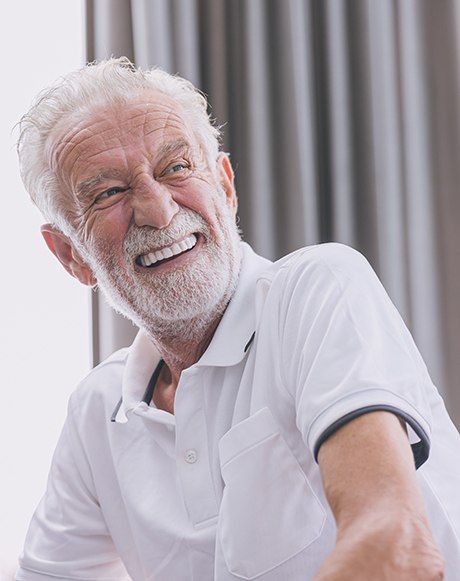 Man laughing on a couch