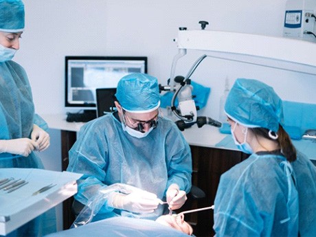 an oral surgeon performing dental implant surgery