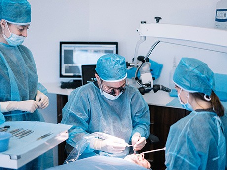 A dental team performing a dental implant surgery