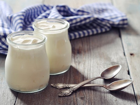 A closeup of Greek yogurt in glass jars